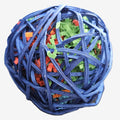 A round bird safe rattan ball toy made of blue wicker, filled with shredded paper filler in green, orange, and blue