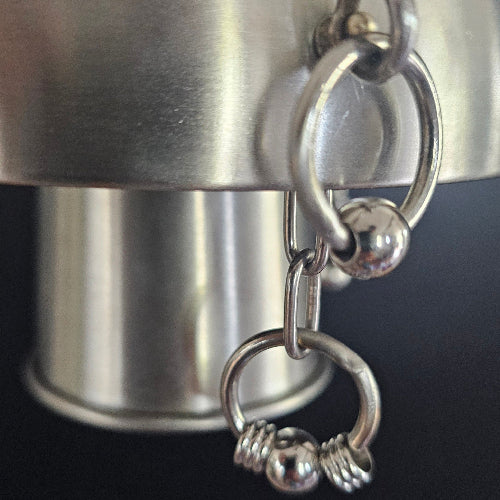 A closeup of the bird safe welded stainless steel beads and chains on the Dualing Jangles